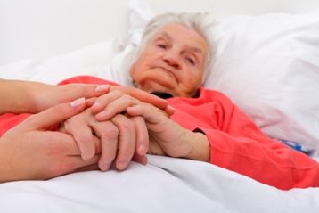elderly woman with her caregiver at home