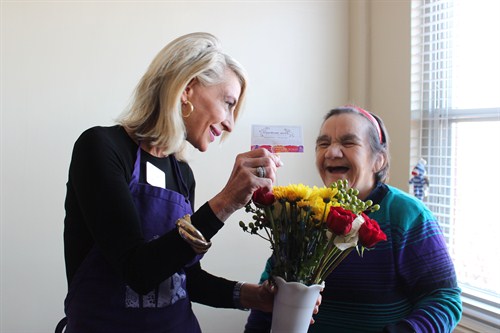 Lupe Krantz Thrilled To Receive A Bouquet From Random Acts Of Flowers Chicago Executive Director Joanie Bayhack
