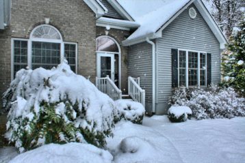 a home in the midst of a fresh snowfall