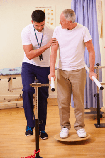 Man assisting older man with stroke rehab care