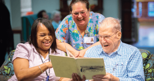 People reading book and enjoying the health benefits of laughter