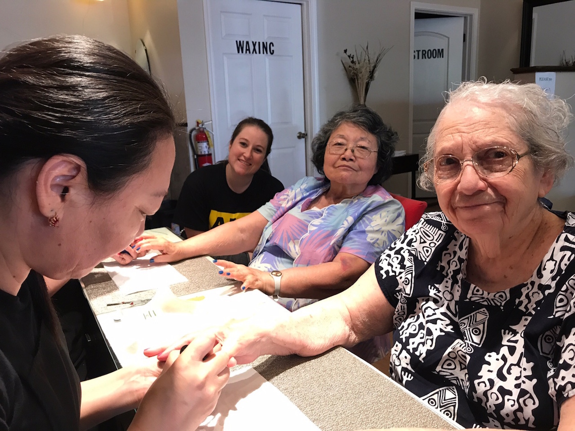 A group of senior get their nails done at a nail salon
