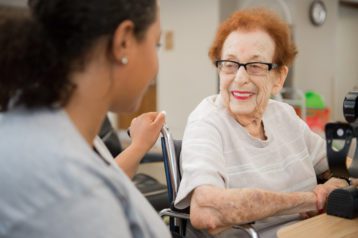 An older woman and CMSS staff member discuss Alzheimer's Prevention